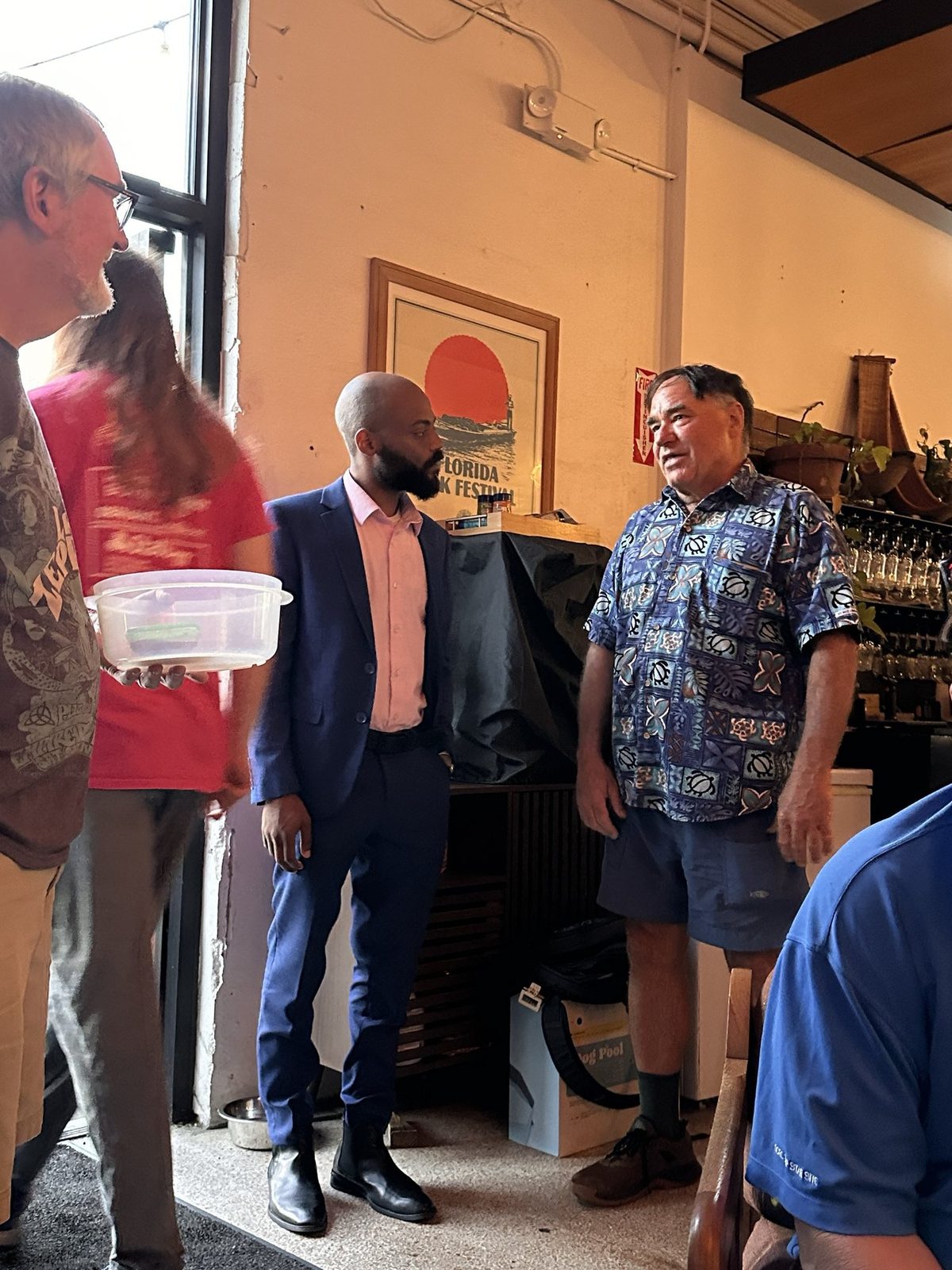 Aaron talking with neighbors at a community event in District 7